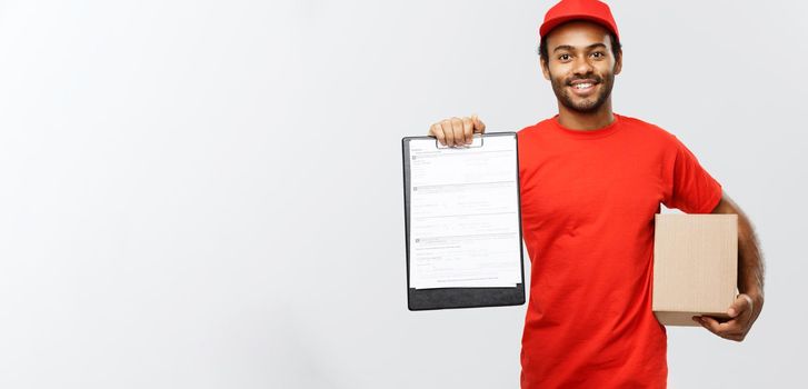 Delivery Concept - Portrait of Handsome African American delivery man or courier showing a confirmation document form to sign. Isolated on Grey studio Background. Copy Space