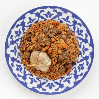 Oriental Uzbek cuisine dish in traditional plate