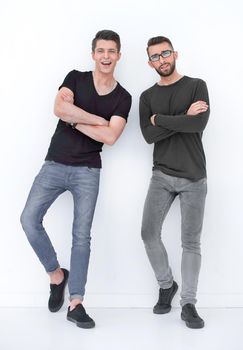 Several ethnic colleagues dressed casually near a white wall indoors