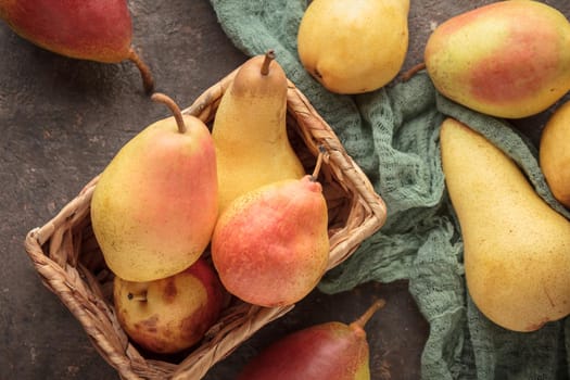 Various ripe pears on a dark background