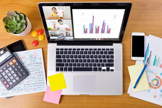Top view Business long distance video call, businessman and businesswoman analysis financial report using videoconference application for virtual communication, online meeting. Covid-19 work from home.