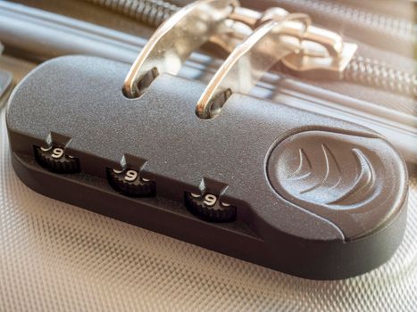 Close up travel bag with zipping number code locked. close-up of silver suitcase number code lock. Summer holiday travel concept.