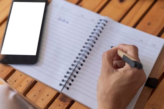 Top view Business women use pen writing document paper. Female hand close up writing with a blue pen on a white sheet. Woman writes information on a piece of paper.