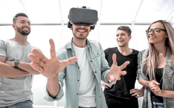 man using Virtual Reality and laughing with arms stretched