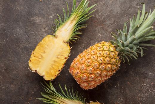 Ripe pineapple on the dark table