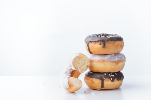 Donuts with dark and white chocolate on a white background