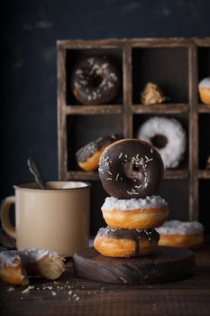 Donuts with dark and white chocolate on a dark background