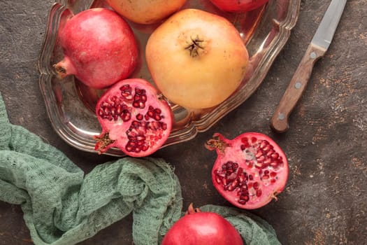 Ripe pomegranates on a dark table background