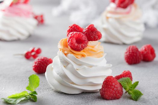 Pavlova dessert with berries on a gray background