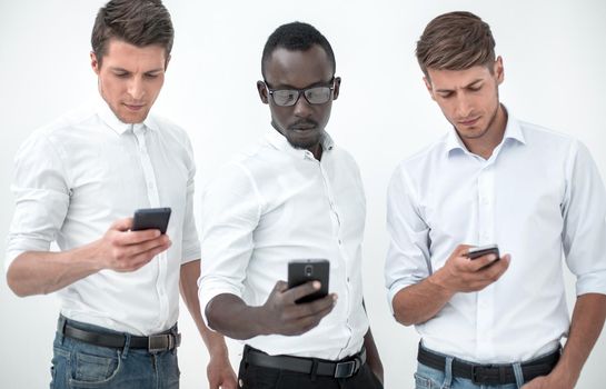 Group young multiethnic business people using mobile phones isolated over white background