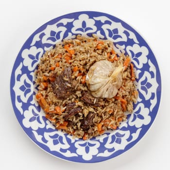Oriental Uzbek cuisine dish in traditional plate