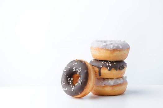 Donuts with dark and white chocolate on a white background