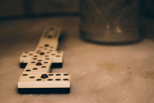 Domino pieces and an anise bottle on a table