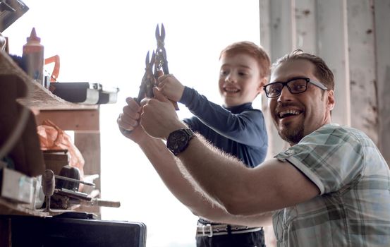 close up. happy father his little son are working together.the concept of family education