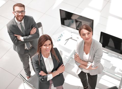 top view. three employees standing in the office. the concept of professionalism