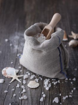 Sea salt crystals with seashells on a dark background