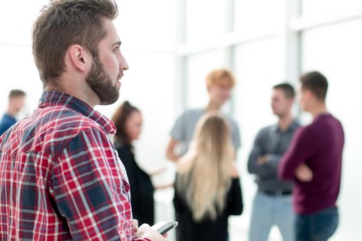 close up. pensive young man standing in the office lobby