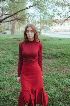 mysterious girl in red walking through the forest