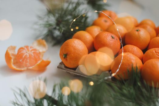 Christmas background with fir tree branches and tangerines. Merry Christmas and Happy New Year Greeting Card. Copy space. Top view. High quality photo