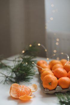 Christmas background with fir tree branches and tangerines. Merry Christmas and Happy New Year Greeting Card. Copy space. Top view. High quality photo