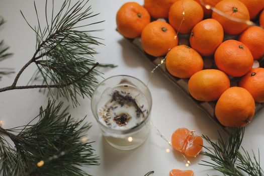 Christmas background with fir tree branches and tangerines. Merry Christmas and Happy New Year Greeting Card. Copy space. Top view. High quality photo