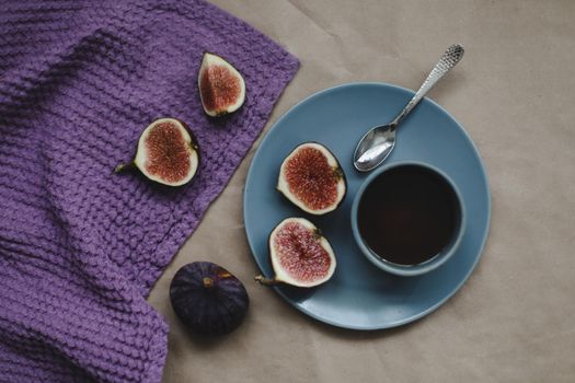 still life with ripe fresh figs and purple textiles