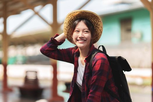 Beautiful traveler with backpack go to summer trip by train. Travel concept