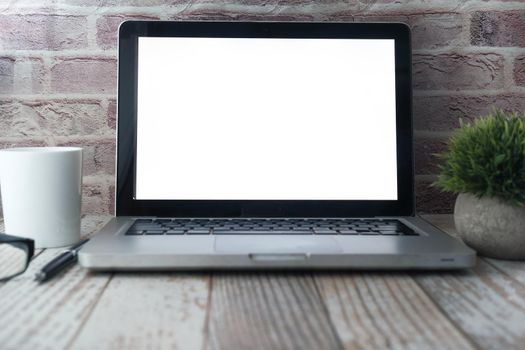 laptop with blank screen on office desk