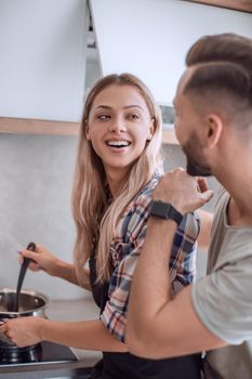 close up. young man joking with his wife in the kitchen