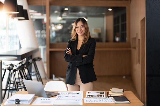 Entrepreneur young asian woman, business woman arms crossed on workplace at her office.