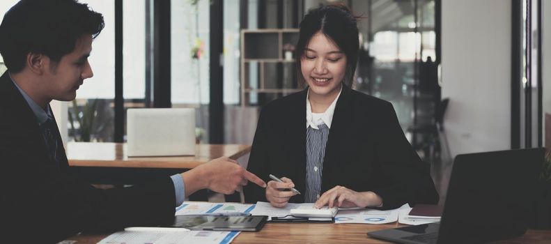 portrait of Asian supervisor boss teach diverse staff workers explain project plan paperwork at group meeting, training business team at corporate office briefing.