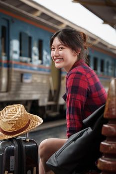 Beautiful traveler with backpack go to summer trip by train. Travel concept