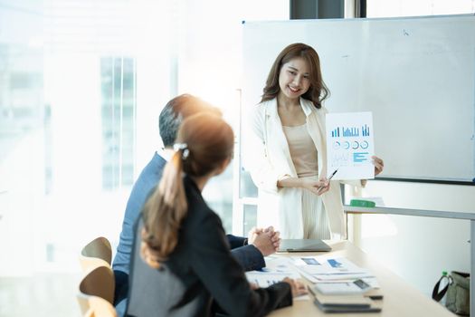 Asian business adviser meeting to analyze and discuss the situation on the financial report in the meeting room.Investment Consultant, Financial advisor and accounting concept