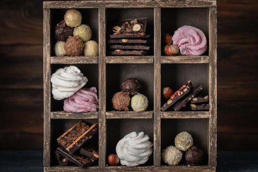 Assorted chocolate sweets in a dark box