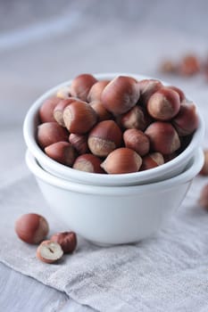 Hazelnuts in a white bowl on the table