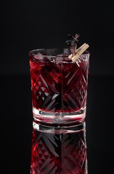 Cocktail in a glass on a black background vertical