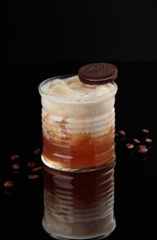 Cocktail in a glass on a black background vertical