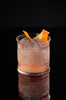 Cocktail in a glass on a black background vertical