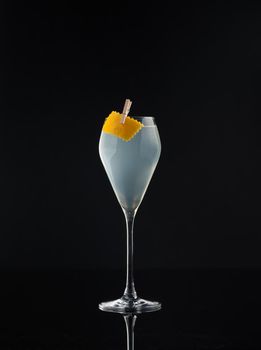 Cocktail in a glass on a black background vertical