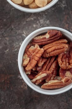 Organic penan nuts on a dark background macro