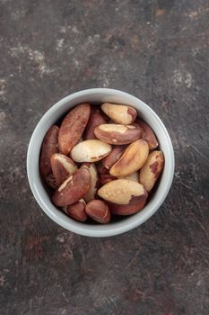 Organic Brazil nuts on a dark background macro