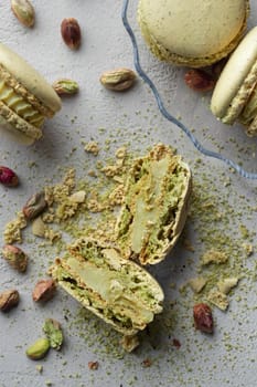 Pistachio flour and green macaroons on a gray background
