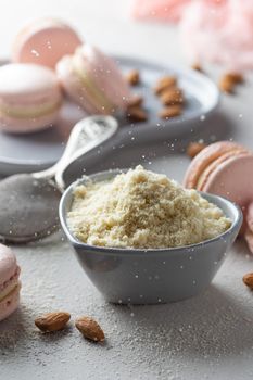 Pink macaroons with almond flour on a gray background