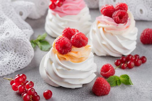 Pavlova dessert with berries on a gray background