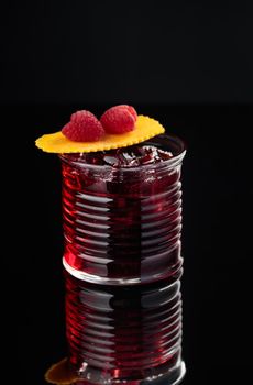 Cocktail in a glass on a black background vertical