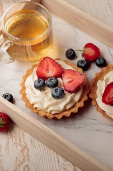 Mini tart with cream cheese and berries top view