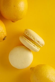 Lemon macaroons on a yellow background vertical