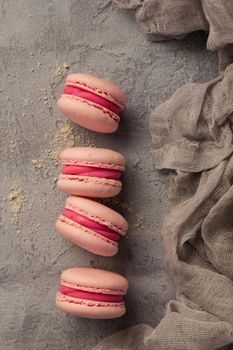 Colorful pink macaroons on a gray table