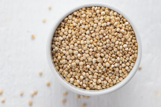 quinoa seeds in a white bowl top view macro