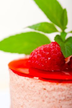 fresh raspberry cake mousse dessert round shape with mint leaves